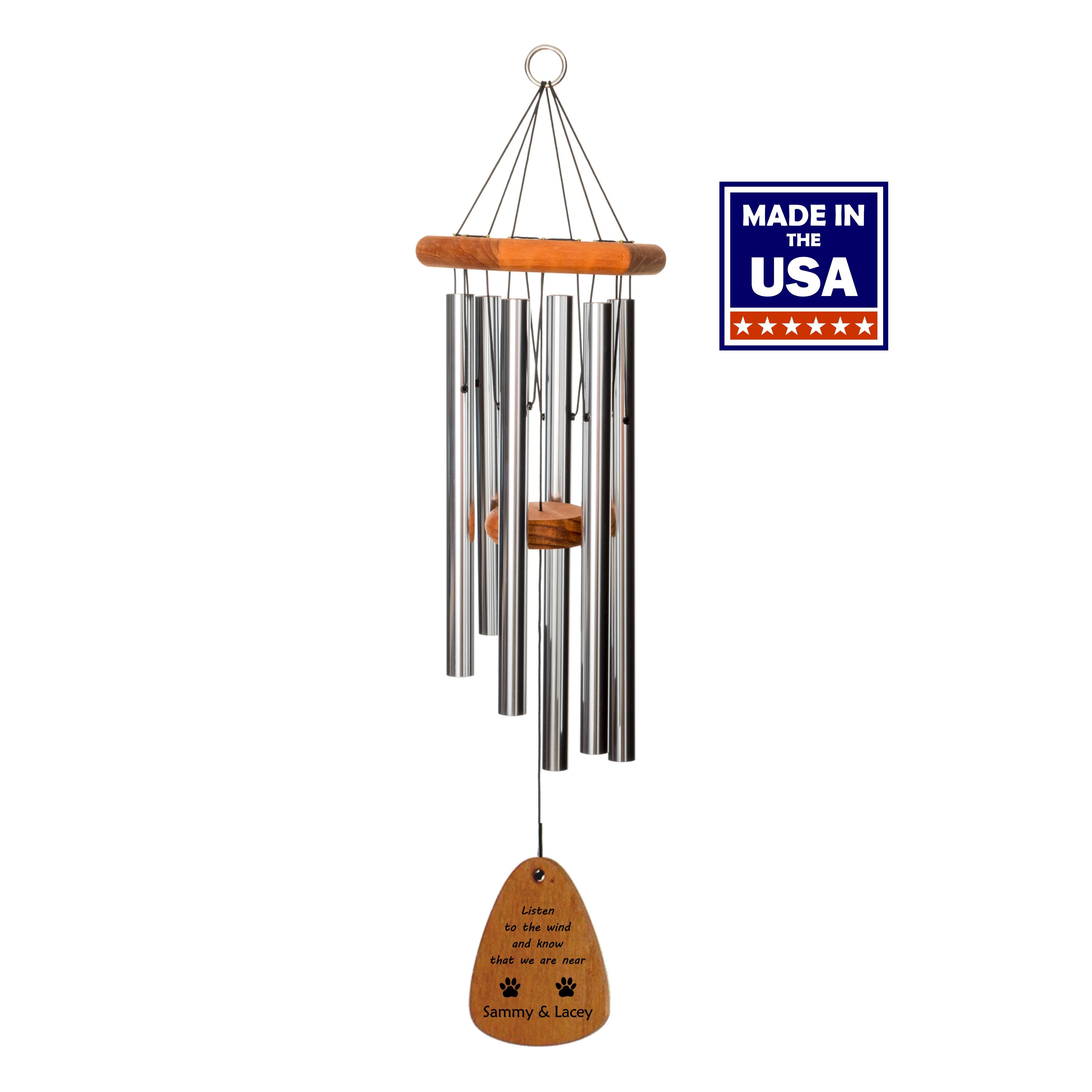 Wind chime with silver tubes and wood accents with the saying Listen to the Wind and know that we are near along with two paw prints and the personalization of two pet names.